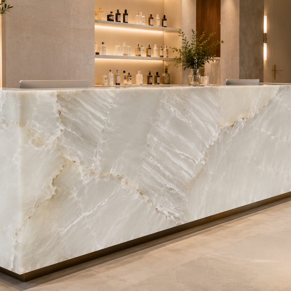 Backlit reception counter in Onyx Artic White, a Stone Experience project